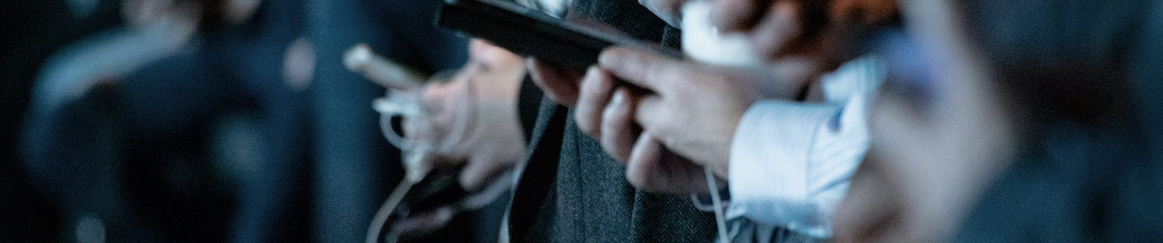 Bilde av mange hender som holder på telefoner